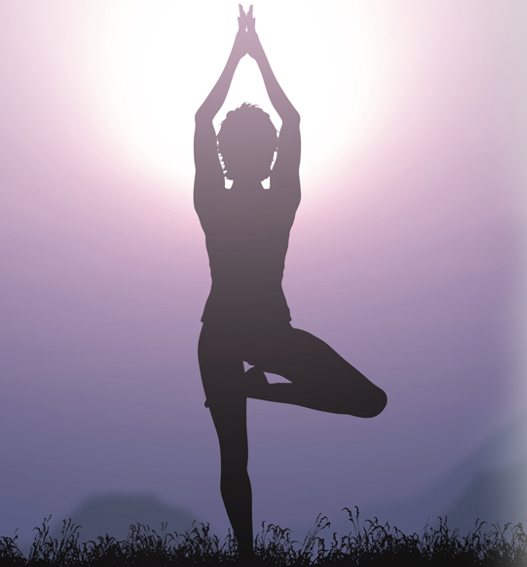 A figure standing in a calm balance pose against a soft evening sky.